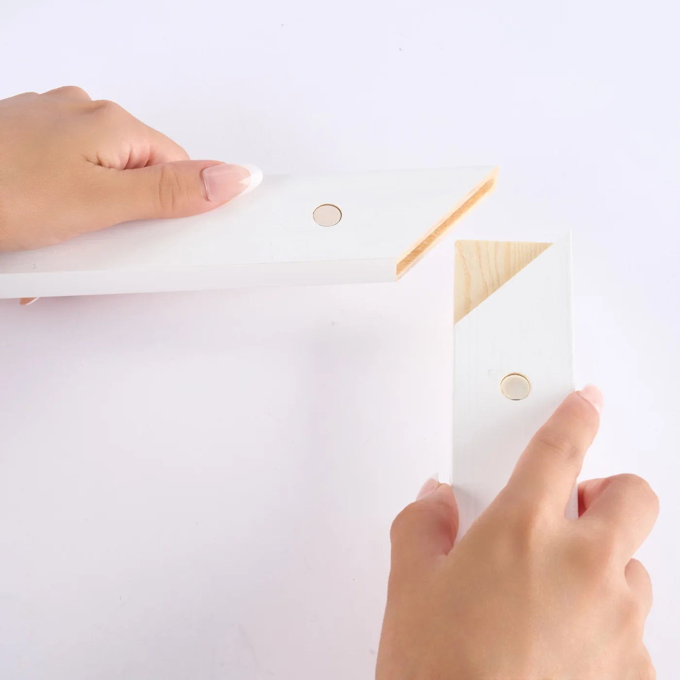 Hands connecting the overlapping wood corner joints