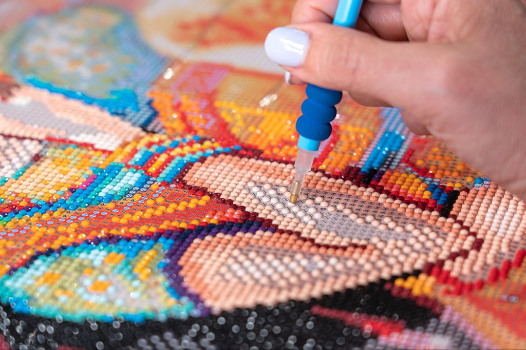 a person filling in an arm on a diamond painting of a person