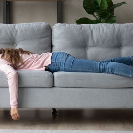 bored woman napping on couch