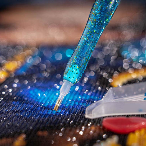 closeup of drill pen and canvas