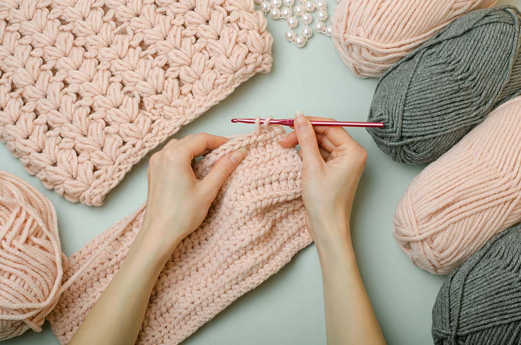 crochet hands threads pink grey