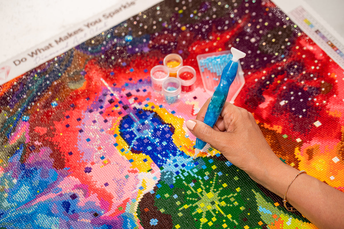 diamond painting with drill in hand