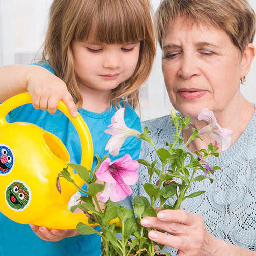 mother daughter watering flowers