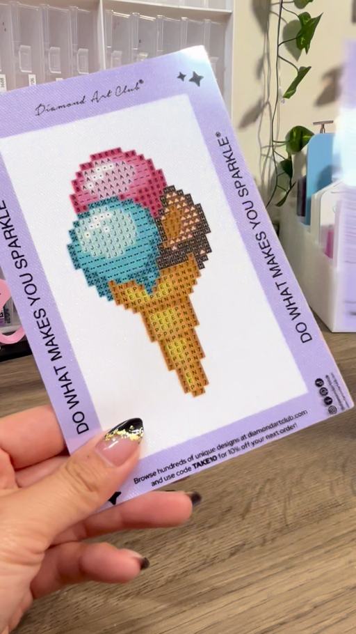 A creator holding a Sweet Treats Mini Dazzles ice cream canvas