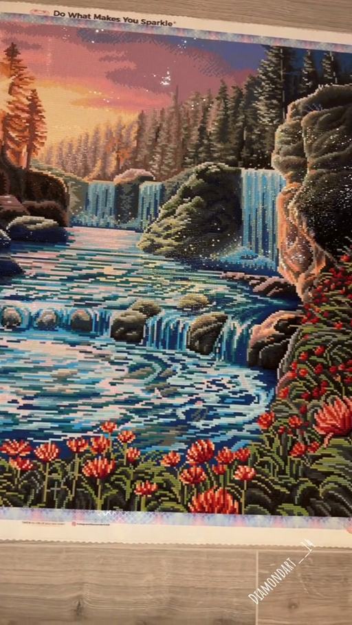 The finished Waterfall Sunset canvas with sparkling turquoise water and a warm orange sky