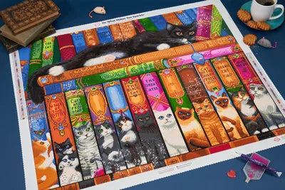 A Cat Bookshelf diamond painting styled with books, coffee and a diamond tray.