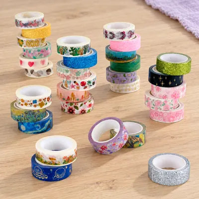 Colorful patterned washi tape rolls arranged on a wooden craft table.